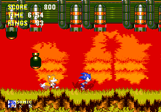 On this long stretch, a large ship will appear above, dropping bombs as it passes overhead! The screen scrolls at a set speed, but all you need to do is keep running and you'll avoid them all easily. If Tails is on auto-pilot, he'll really take a battering though!