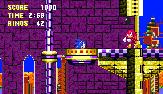 Just before the boss, Sonic comes face to face with Knuckles once again, as he sits helplessly inside a yellow cup object while Knuckles withdraws a bomb and hurls it to the bottom of the building they're in..
