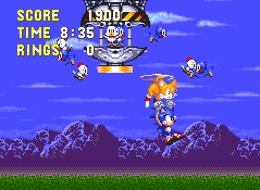 After defeat, the usual capsule will float down from above and you need to use Tails' backside to hit the button.