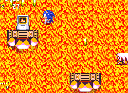 Do a little exploring and you'll find several collections of rings and power-ups on stable platforms, while columns of pink platforms continue their descent. Most significant here is this fire shield, found on the far left. Get it to make the rest of the boss much easier.